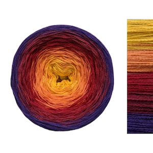 May include: A skein of ombre yarn in shades of purple, red, orange, and yellow. The yarn is wound into a ball and shows the color transitions.