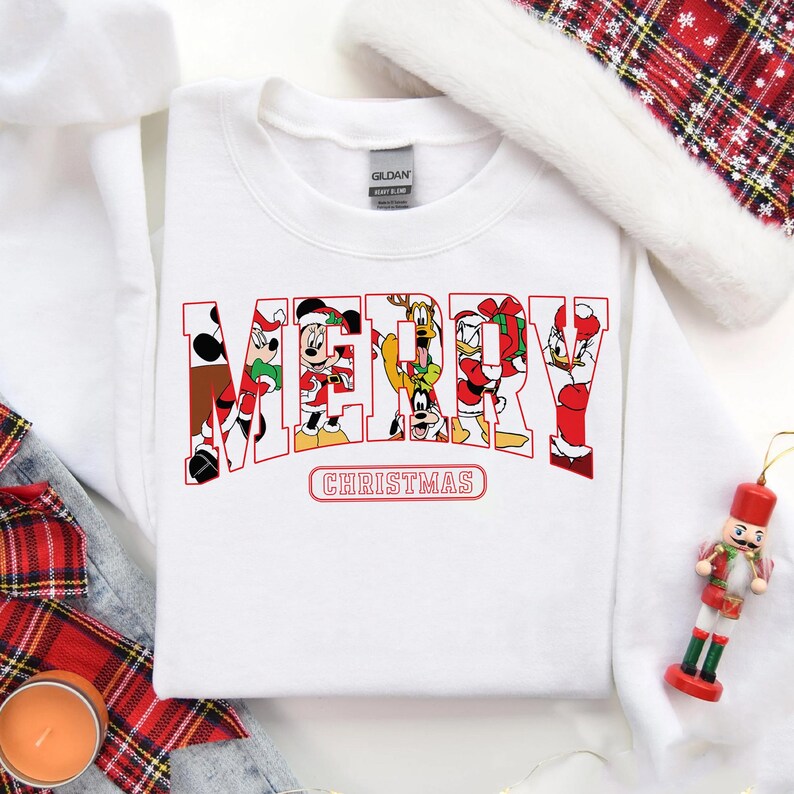May include: White Christmas sweatshirt with a red "Merry Christmas" graphic featuring Mickey Mouse, Minnie Mouse, Donald Duck, Goofy, and Pluto.