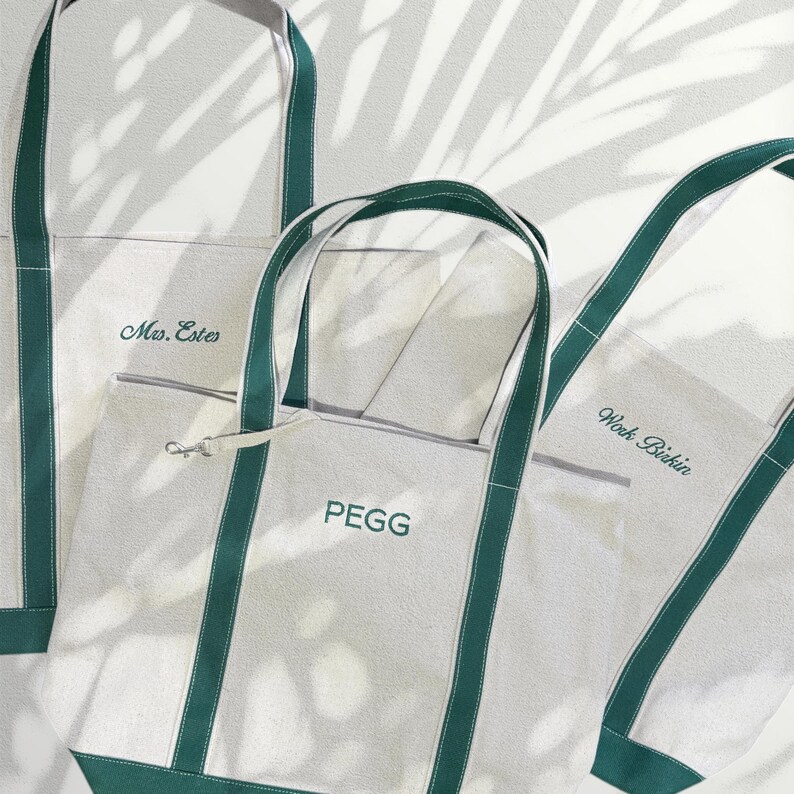 May include: Three white canvas tote bags with green straps. The bags are personalized with the names "Mrs. Estes", "Work. Bikini", and "PEGG".