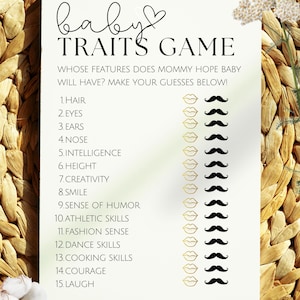 May include: A white baby shower game card with the text "Baby Traits Game". The card features a list of traits with lip and mustache graphics. The background is a woven texture.