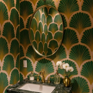 Deco Shells Wallpaper with green and gold fan pattern on light pink background.