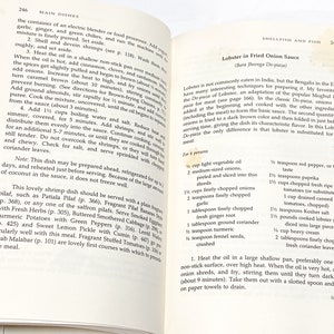 May include: A page from a cookbook with a recipe for Lobster in Fried Onion Sauce. The recipe includes a list of ingredients and instructions for preparing the dish. The text includes the name of the dish in both English and Hindi.