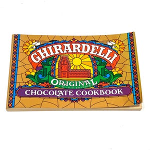 The image is a colorful cookbook cover for the Ghirardelli Original Chocolate Recipe Book.