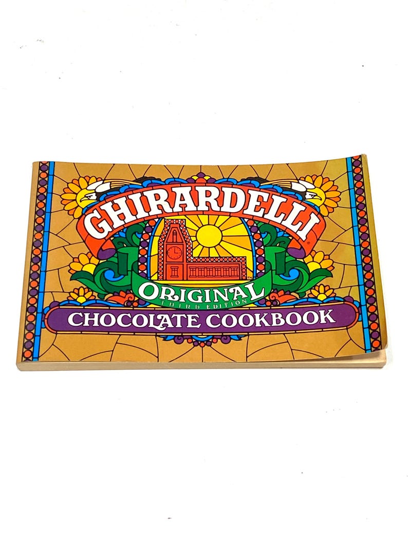The image is a colorful cookbook cover for the Ghirardelli Original Chocolate Recipe Book.