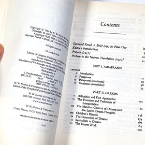 a person holding a book open to a page