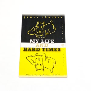 May include: A yellow and black paperback book titled "My Life and Hard Times" by James Thurber. The cover features a black and white illustration of a dog.