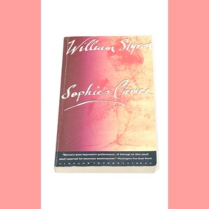 May include: A vintage paperback book cover with a red, orange, and yellow gradient background. The title "Sophie's Choice" is written in cursive script and the author "William Styron" is written in a bold, serif font. The text "Styron's most impressive performance...It belongs on that small shelf reserved for American masterpieces." is printed in black at the bottom of the cover.