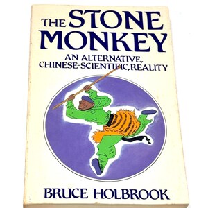 May include: A vintage book titled "The Stone Monkey" by Bruce Holbrook. The cover features a cartoon illustration of a figure in green clothing with a tiger-striped sash, holding a staff. The text is in blue and the background is white.