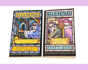 May include: Two vintage paperback books by Ellis Peters. The book covers feature colorful illustrations with text. One book is titled "A Morbid Taste for Bones" and the other is "Monk's Hood". Both books are from the Brother Cadfael series.