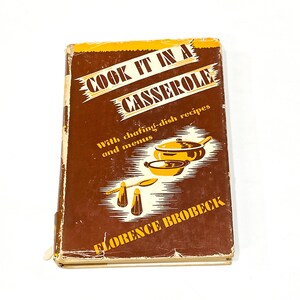May include: A brown cookbook with a yellow title that reads "Cook It In A Casserole" with the subtitle "With chafing-dish recipes and menus" and the author's name "Florence Brobeck".