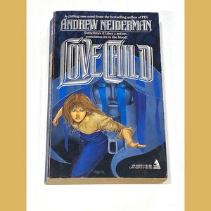 May include: A paperback book titled "Love Child" by Andrew Neiderman. The cover features a woman in a blue dress and a ghostly figure with blue tears. The book has a dark blue background with white lettering.