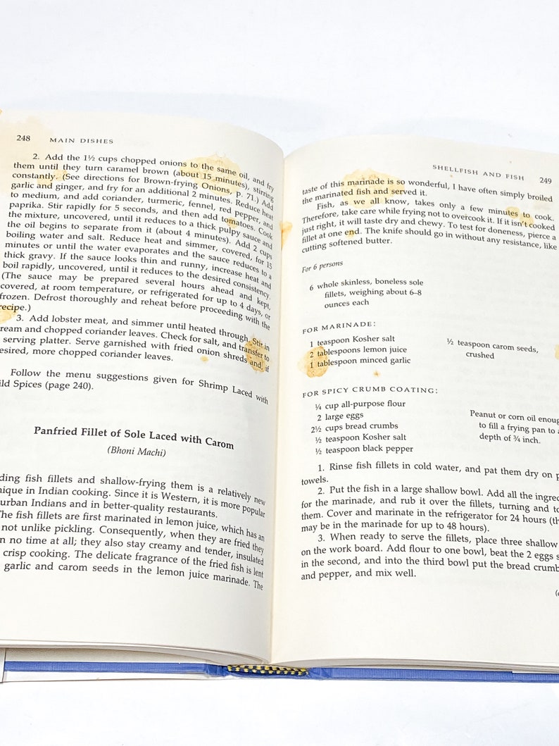 May include: A close-up of a recipe for pan-fried sole fillets with carom seeds. The recipe includes instructions for marinating the fish in a lemon juice marinade and then coating it in a spicy breadcrumb mixture. The recipe also includes a list of ingredients and instructions for preparing the marinade and the breadcrumb coating.