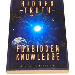 May include: A hardcover book titled "HIDDEN -TRUTH- FORBIDDEN KNOWLEDGE" with a space-themed cover. The cover features a blue and black galaxy background with planets, stars, and the Earth. The author's name is Steven M. Greer M.D.