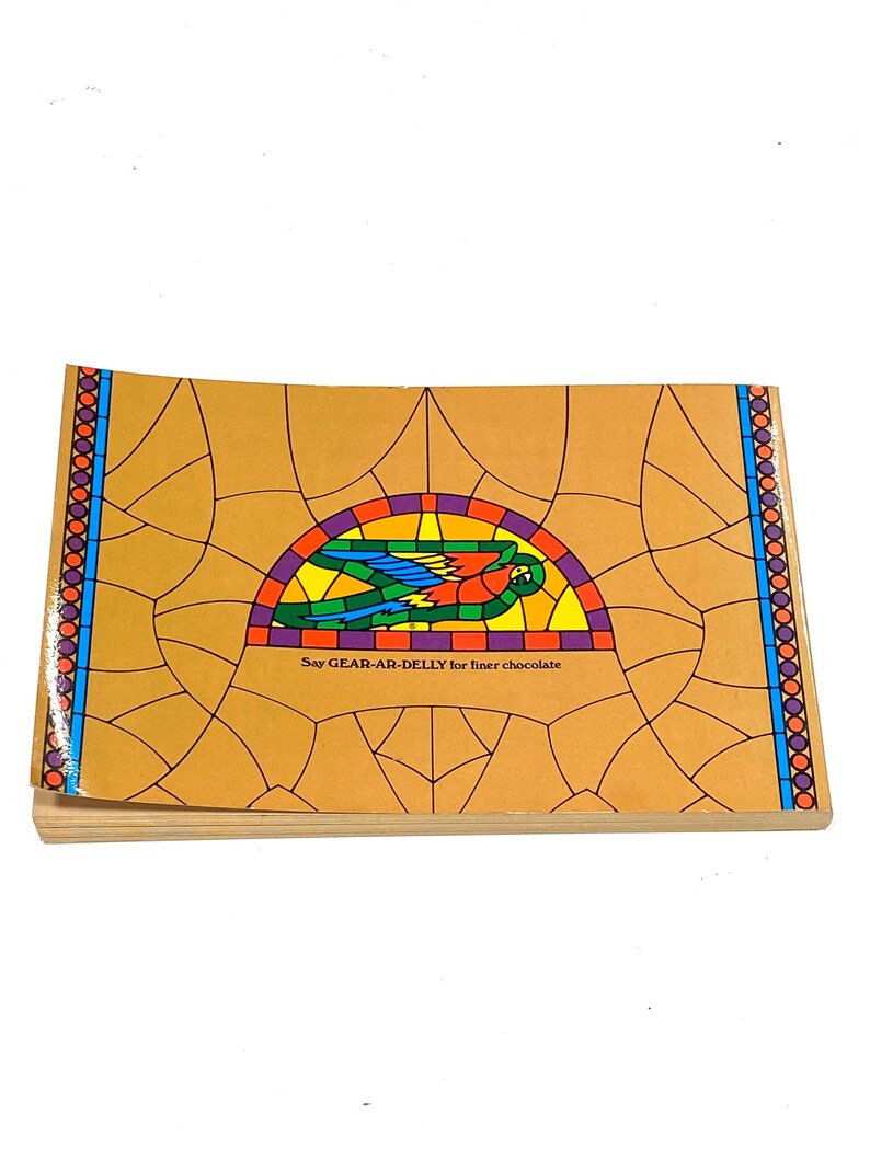 The image is a book cover with a colorful stained glass design featuring a bird and the text "Say GAR-AB Delly for inner chocolate".