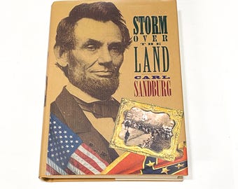 May include: A book cover with a portrait of Abraham Lincoln, the title "Storm Over the Land", and the author's name "Carl Sandburg". The cover also features a small image of a Civil War battle scene and the American and Confederate flags.