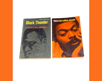 May include: Two vintage paperback books. The first, "Black Thunder" by Arna Bontemps, features a black and white portrait. The second, "Tales by LeRoi Jones," has an orange cover with a portrait. Both books are on a white background.