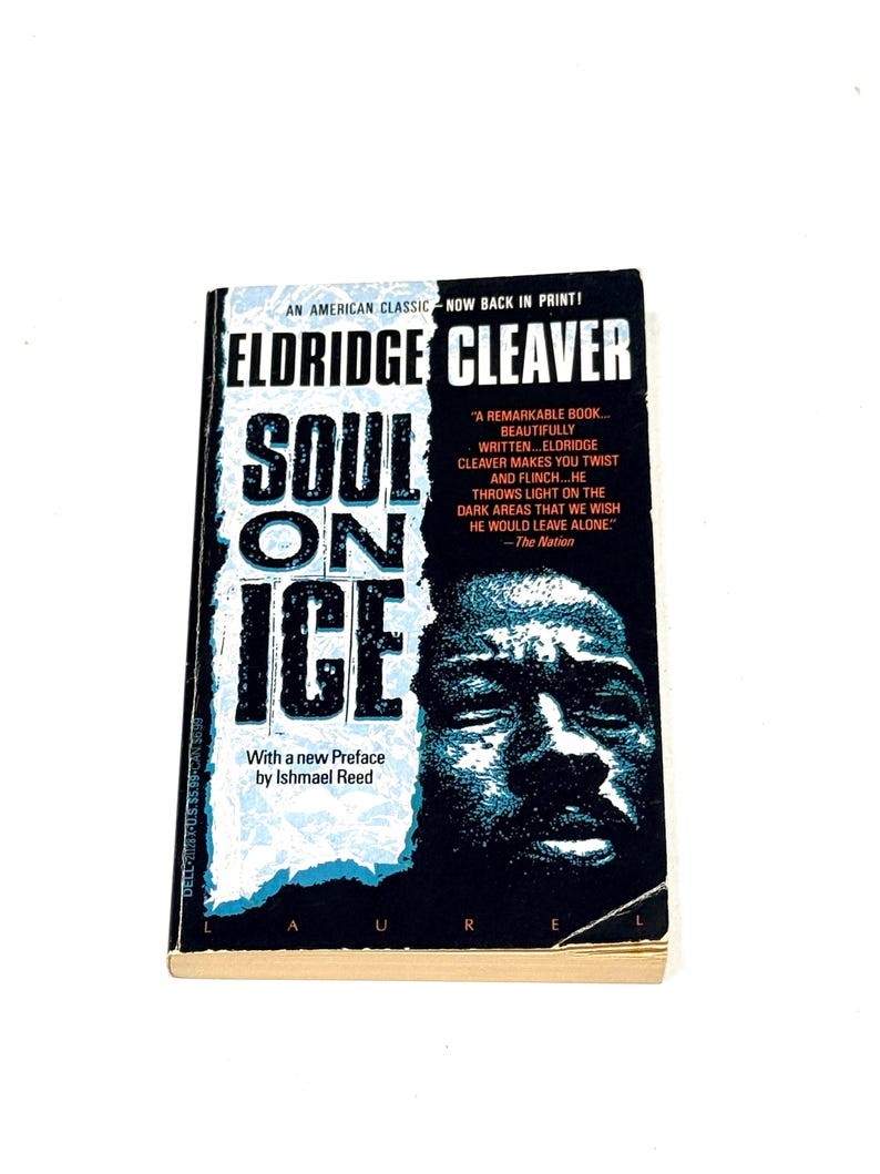 May include: A paperback book titled "Soul on Ice" by Eldridge Cleaver. The cover features a portrait of a man and the book's title in large, bold letters. The book is an American classic, now back in print.