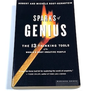 May include: A paperback book titled Sparks of Genius: The 13 Thinking Tools of the World's Most Creative People by Robert and Michèle Root-Bernstein. The black cover features a graphic of a lit match with a bright orange and yellow flame.