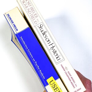 a person holding a tube of toothpaste in their hand