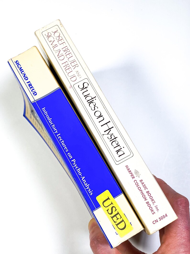 a person holding a tube of toothpaste in their hand