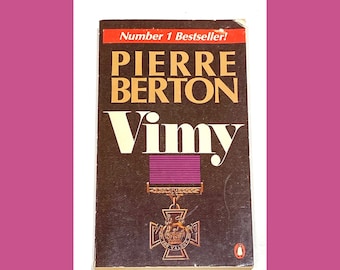 May include: A brown paperback book with the title "Vimy" by Pierre Berton. The book cover features a purple ribbon and a medal with the words "For Valor". The book is a number one bestseller.