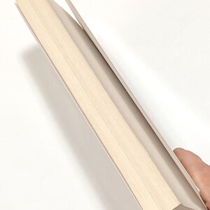 a person holding a piece of wood in their hand