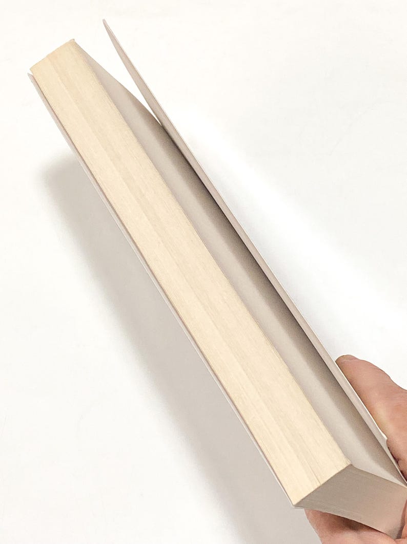 a person holding a piece of wood in their hand
