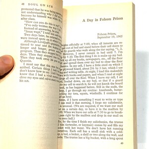May include: An open book with text on the pages. The left page has the title "SOUL ON ICE" and the number 48. The right page has the title "A Day in Folsom Prison" and the date "September 19, 1965".