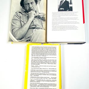 an open book with a picture of a man in a suit