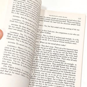 a person holding a book open to a page