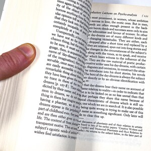 a hand is touching a book with a finger