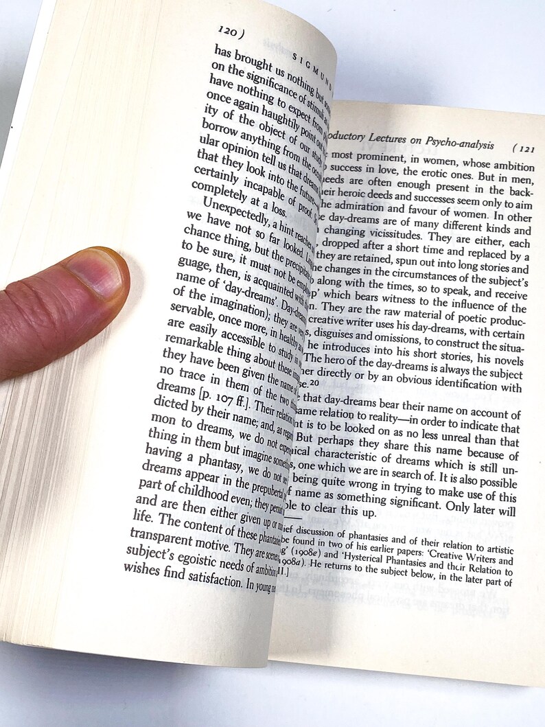 a hand is touching a book with a finger