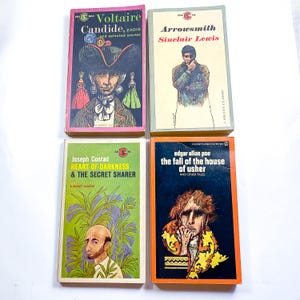 May include: Four vintage paperback books with colorful covers. The books are titled "Candide", "Arrowsmith", "Heart of Darkness & The Secret Sharer", and "The Fall of the House of Usher".