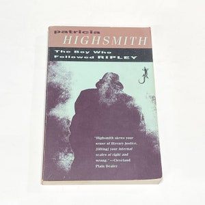 May include: A paperback book cover with a dark purple background and a silhouette of a person wearing a hat. The title of the book is "The Boy Who Followed Ripley" by Patricia Highsmith. A quote from a review of the book is printed on the bottom of the cover.