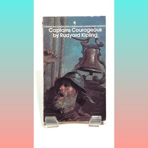 May include: A vintage paperback book cover with a painting of a man on a ship looking up at a bell. The title of the book is "Captains Courageous" by Rudyard Kipling.