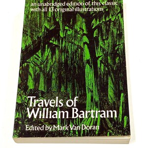 May include: A hardcover book titled "Travels of William Bartram" with a green and black illustration of a swamp scene. The cover also includes the text "an unabridged edition of this classic with all 13 original illustrations."