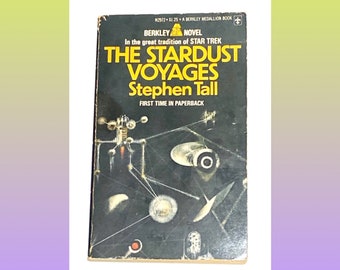 May include: A paperback book cover with a black background and a yellow title: "The Stardust Voyages" by Stephen Tall. The cover features a spaceship and other space-related imagery.