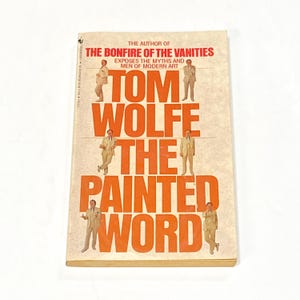 May include: A vintage paperback book titled "The Painted Word" by Tom Wolfe. The cover features the author's name in large orange letters, with the title below. The book's cover also includes images of men in suits.