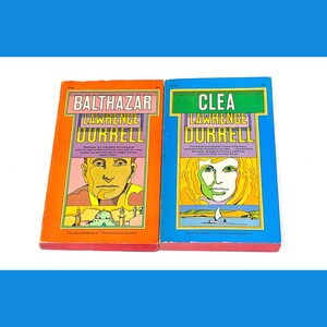 May include: Two paperback books, "Balthazar" and "Clea", both part of "The Alexandria Quartet" by Lawrence Durrell. The covers feature colorful illustrations and text.