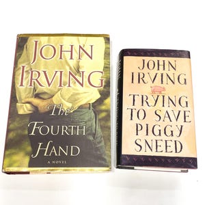 May include: Two paperback books by John Irving. The book on the left is titled "The Fourth Hand, A Novel". The book on the right is titled "Trying to Save Piggy Sneed".