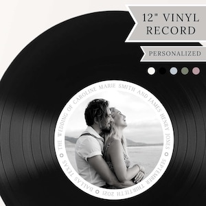 May include: A 12-inch black vinyl record featuring a personalized circular center label with a black and white photograph of a couple embracing. The label text reads: THE WEDDING OF CAROLINE MARIE SMITH AND JAMES HENRY JONES SEPTEMBER THIRTIETH 2021 DALLAS TEXAS.