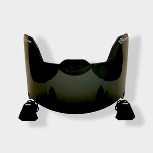 May include: Black visor with a curved design and a "PRECISION" logo on each side. The visor has a dark tint and is made of a durable material.