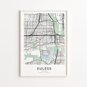 May include: A framed map print of Euless, Texas, featuring a detailed black and white street layout with green and tan shaded areas. The city name and coordinates are printed at the bottom. The print is in a white frame.