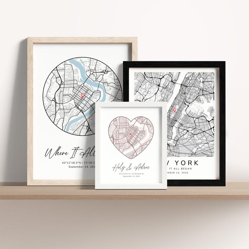 May include: Three framed maps with black and white city outlines and red heart markers. The top map is a circle with the text "Where It All Began" and coordinates. The middle map is a heart shape with the text "Holy & Adam" and coordinates. The bottom map is a rectangle with the text "/YORK It All Began" and coordinates.