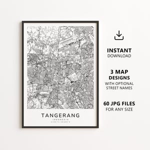 May include: A framed black and white map print of Tangerang, Indonesia, featuring a detailed street grid and airport layout. The text at the bottom reads TANGERANG INDONESIA 6.1703 S / 106.6403 E. To the right, text indicates instant download availability.