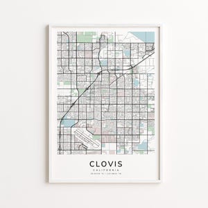 May include: A framed map print of Clovis, California, featuring a detailed street grid, parks, and waterways in shades of gray, green, and blue. The city name is centered at the bottom, with the state and coordinates below.