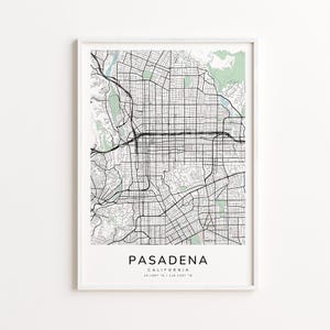 May include: A framed map print of Pasadena, California, featuring a detailed street grid in black and white. Green areas represent parks and natural features. The city name is centered at the bottom, with coordinates.