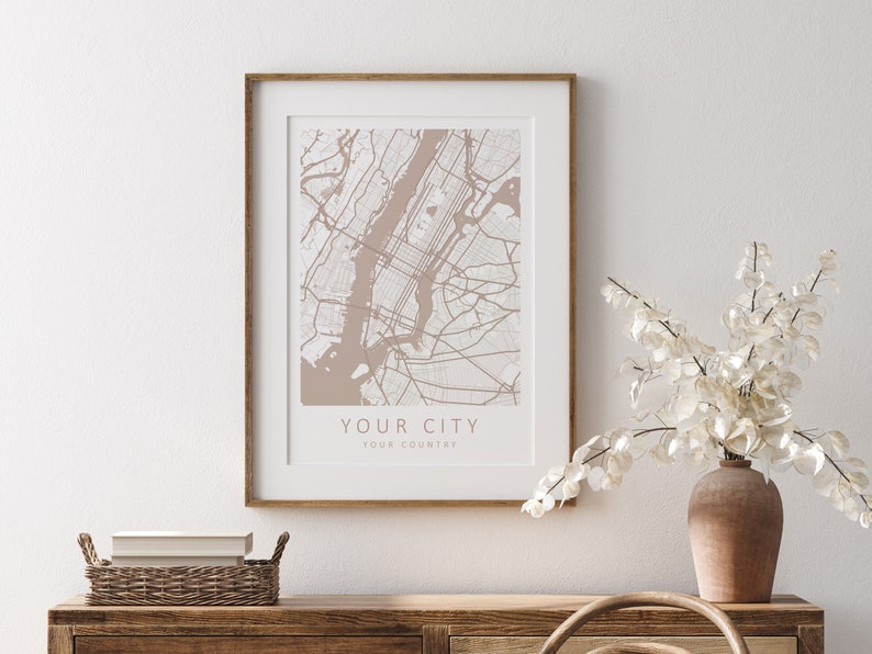 Mockup map print example. The map is displayed in a wooden frame with a mat on a white wall.
The example pictures are in portrait. The displayed map is in a beige color scheme.