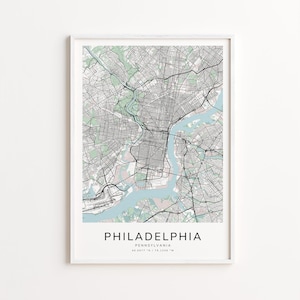 May include: A framed map print of Philadelphia, Pennsylvania, featuring a detailed black and white street grid with light blue waterways and green park areas. The city name is centered at the bottom.
