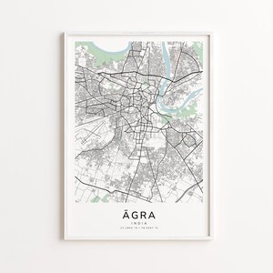 Peut inclure: Une impression encadrée d'une carte d'Agra, en Inde, en noir et blanc. La carte montre les routes, les bâtiments et les cours d'eau de la ville. Le nom de la ville, Agra, est imprimé en police moderne en bas de l'impression, avec les coordonnées.